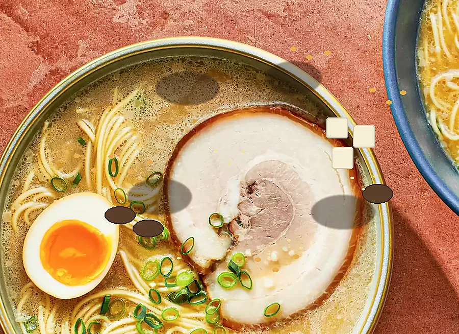 black-garlic tonkotsu ramen bowl with egg, pork, mushrooms, tofu, sesame, and tenkasu